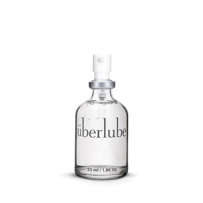 Clear spray bottle labeled 'uberlube' on a white background